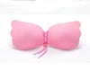 Pink strapless bra with lace-up front, soft silicone material, winged cups for seamless fit