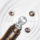 Metallic skincare tool with smooth silver tip and bronze body, close-up on white background