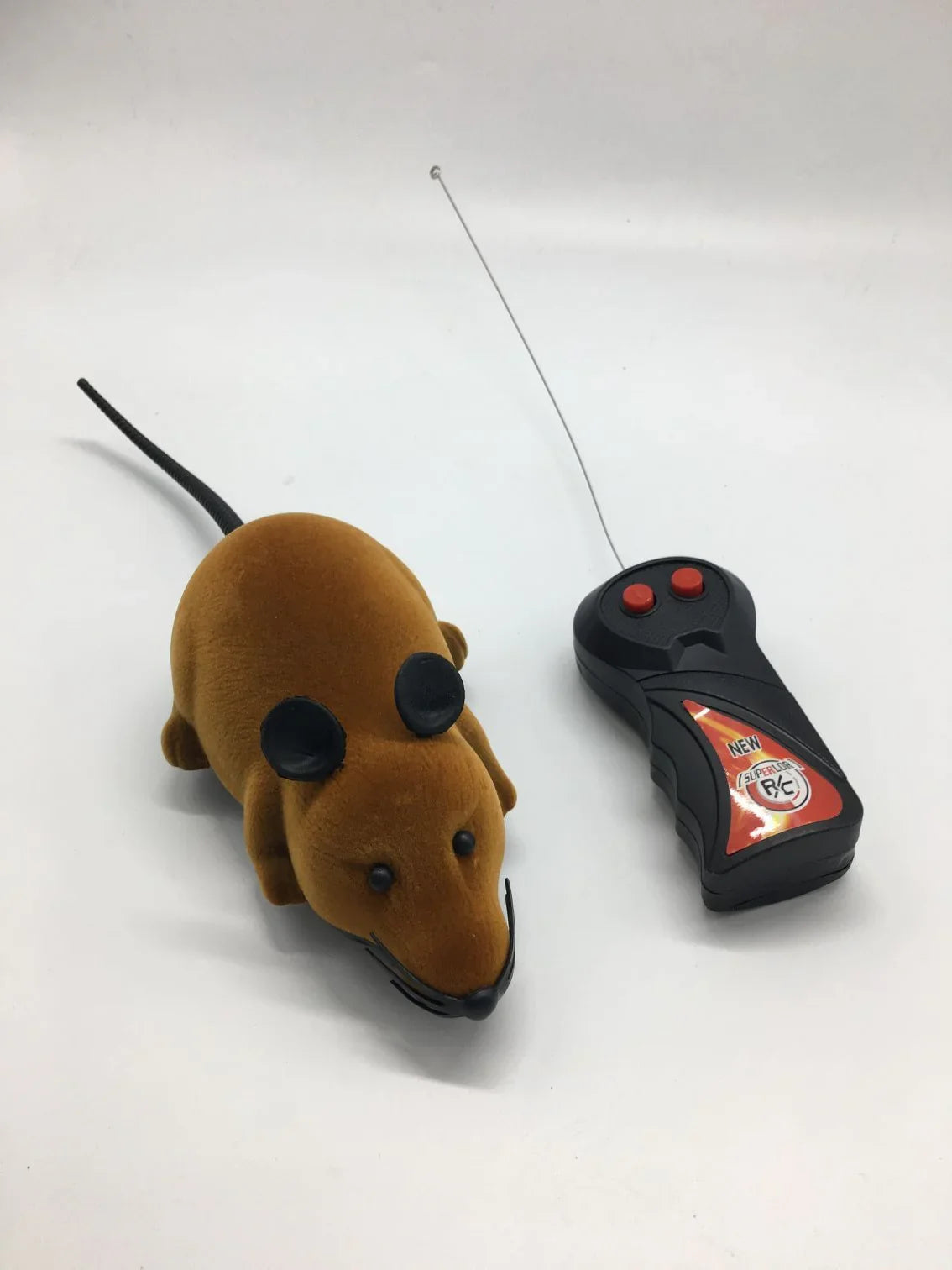 Brown plush remote control mouse toy with black ears and wireless controller on white background