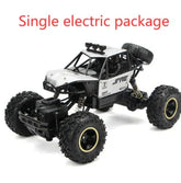Black and silver electric remote control off-road car with rugged large tires on white background.
