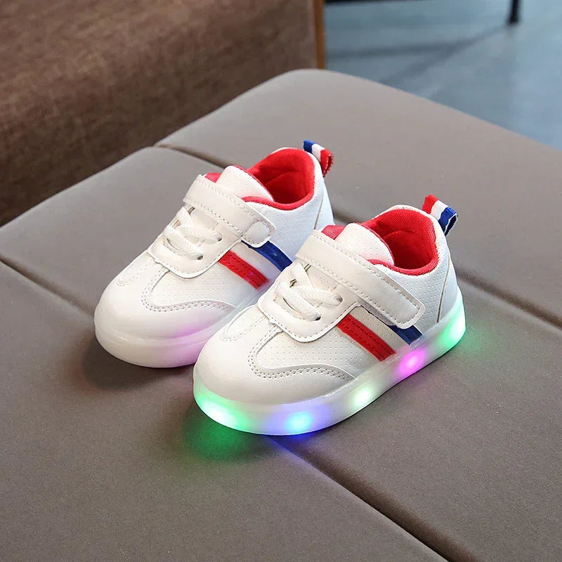 White kids sneakers with red and blue accents, light-up soles, velcro straps, mesh material