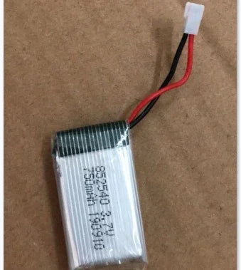 Small silver lithium polymer battery with red and black wires and connector on brown background