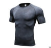 Black textured compression t-shirt with short sleeves, form-fitting athletic fit, breathable mesh-like material