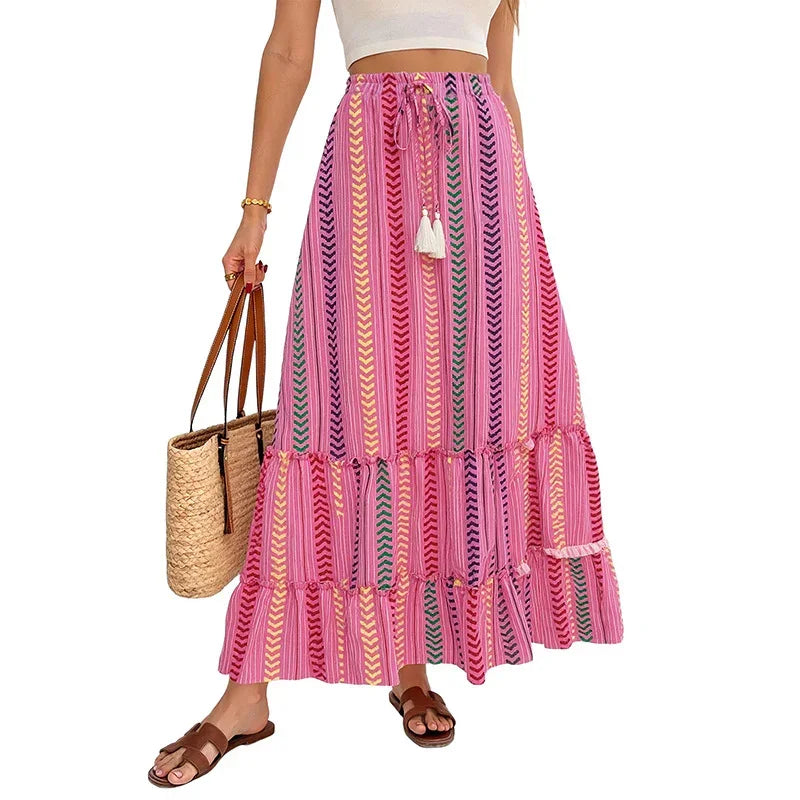 Woman wearing a colorful pink striped boho maxi skirt with chevron patterns, flowy fit