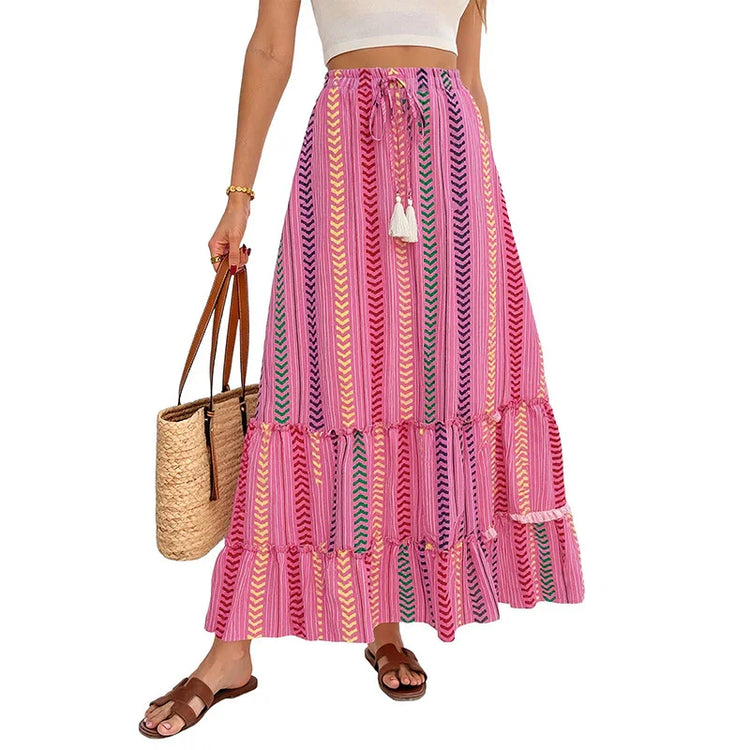 Woman wearing a colorful pink striped boho maxi skirt with chevron patterns, flowy fit