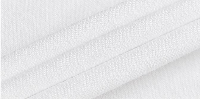 Close-up of white cotton fabric showing soft texture and smooth weave