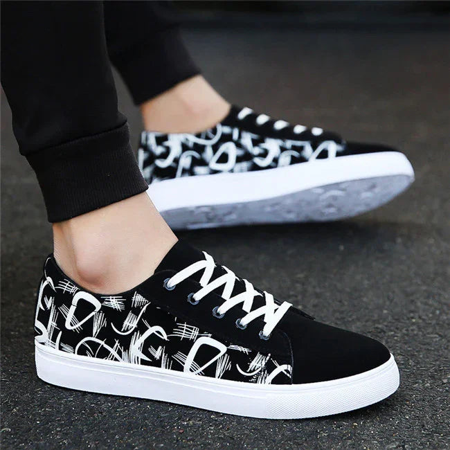 Black and white low-top sneakers, graphic print, canvas material, modern streetwear style