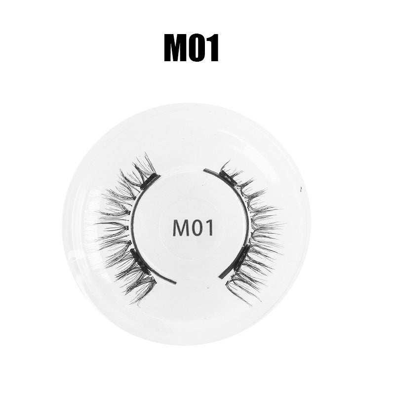 Black synthetic false eyelashes M01 style in a round clear tray, wispy and lightweight fit