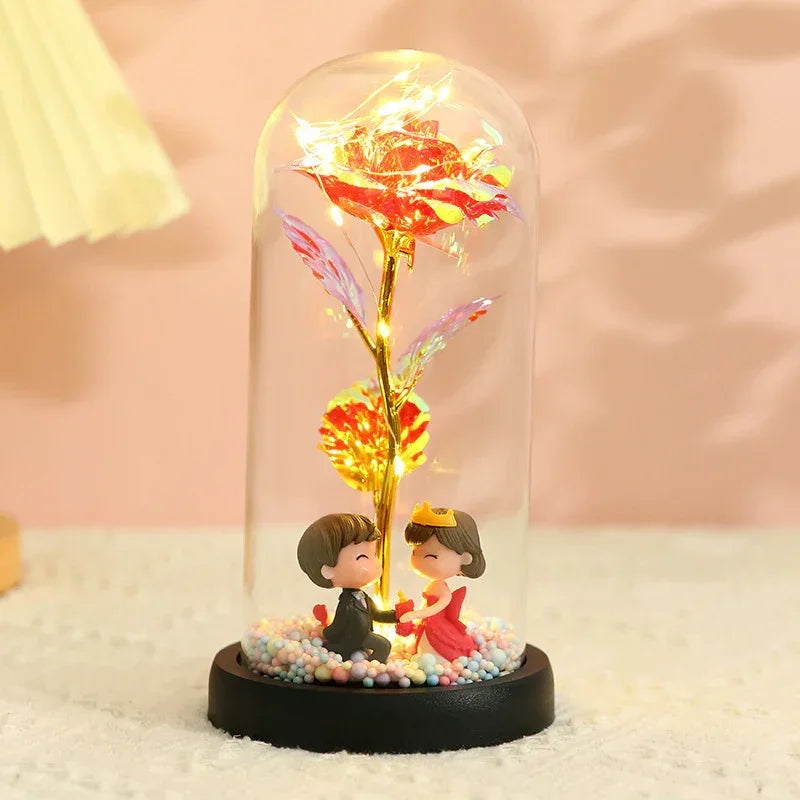 Romantic figurines in formal wear under a glass dome with LED rose, soft pastel decor