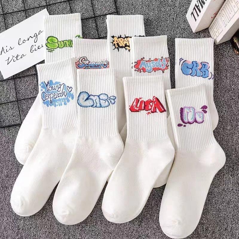 White cotton crew socks with colorful graffiti text designs, streetwear style, casual fit