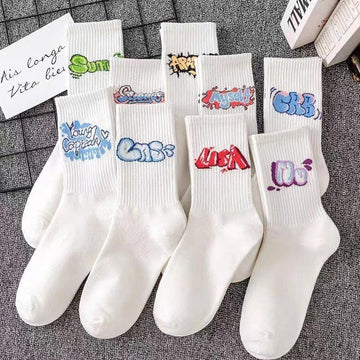 White cotton crew socks with colorful graffiti text designs, streetwear style, casual fit
