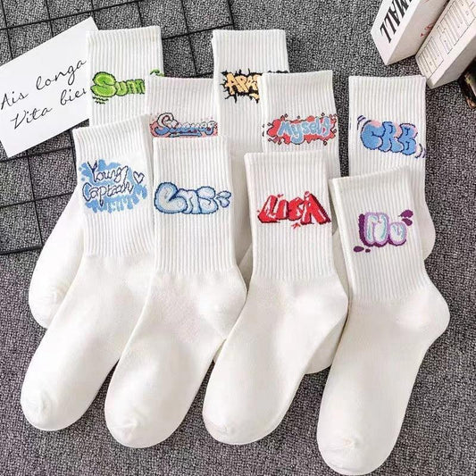 White cotton crew socks with colorful graffiti text designs, streetwear style, casual fit