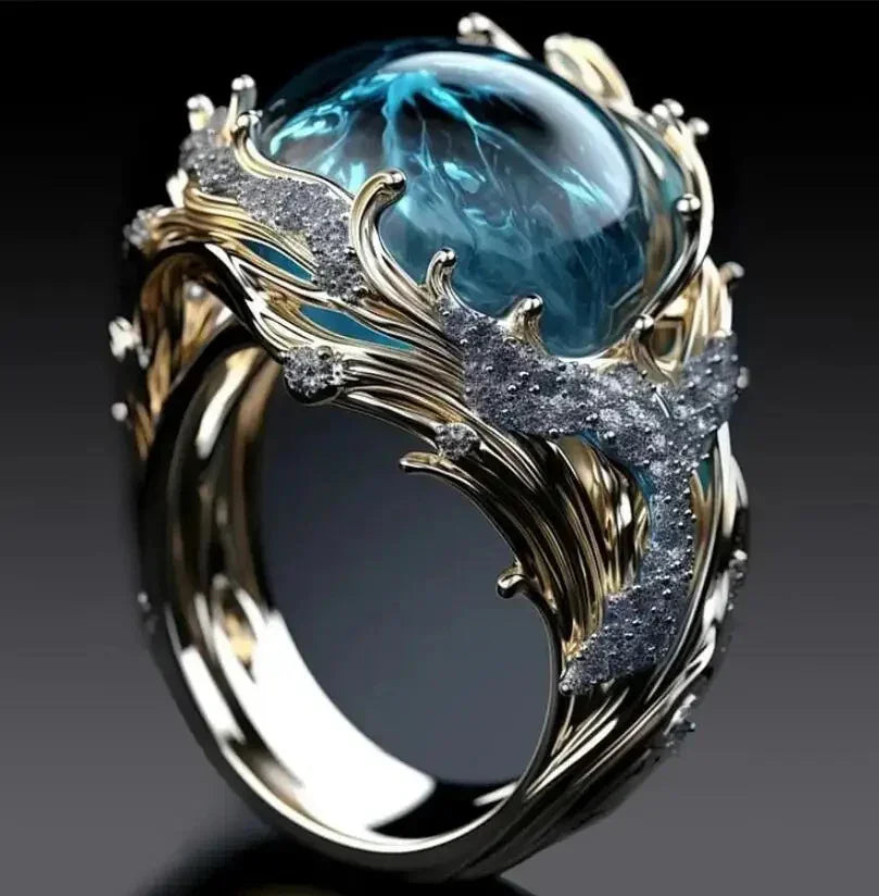 Gold ring with intricate silver wave design, large blue gemstone, and diamond accents