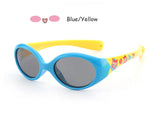 Blue and yellow oval sunglasses with cartoon print arms and dark lenses, plastic frame