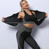 Woman wearing black and gray seamless textured activewear set with fitted crop top and leggings