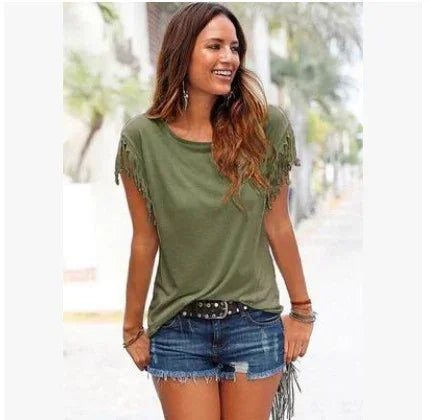 Woman wearing olive green fringe sleeve t-shirt and distressed denim shorts outdoors