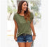 Woman wearing olive green fringe sleeve t-shirt and distressed denim shorts outdoors