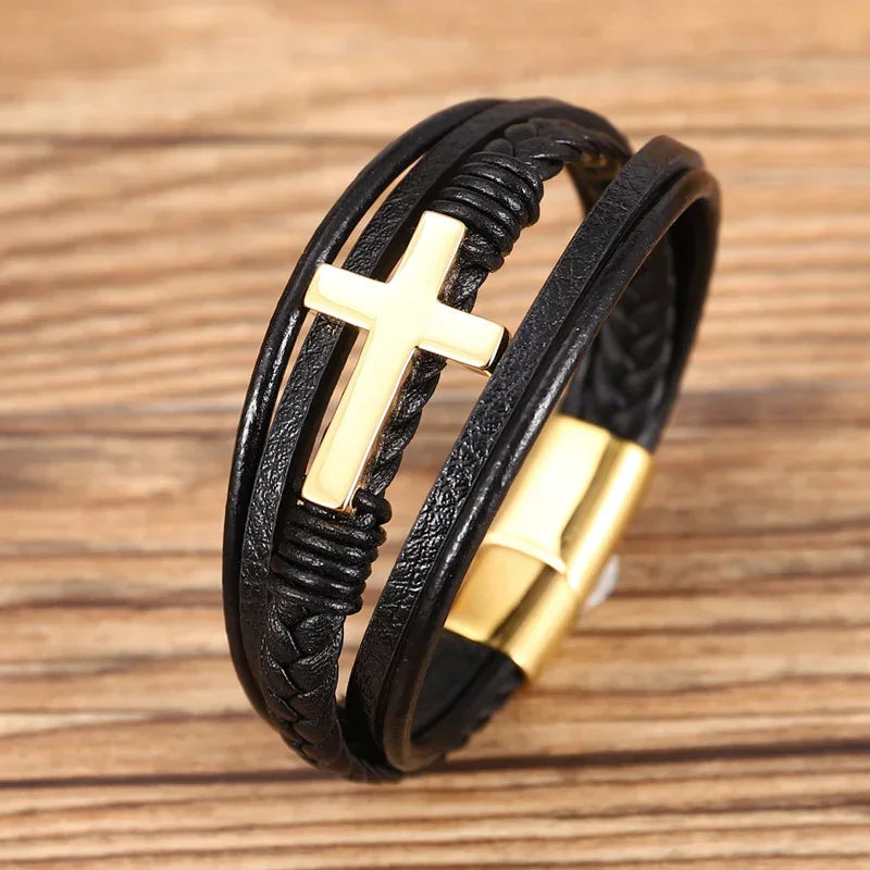 Black leather bracelet with gold cross accent and woven details, adjustable fit