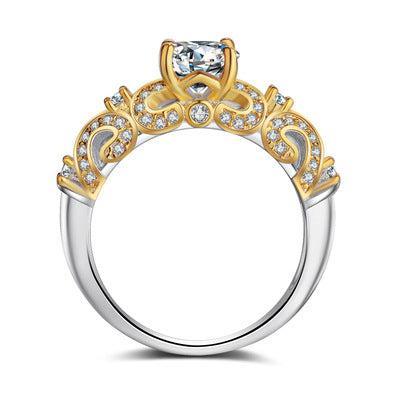 Elegant two-tone ring with gold filigree, clear crystals, and a central gemstone, ornate style