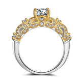 Two-tone gold and silver ornate ring with clear gemstone and intricate detailing