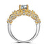 Two-tone gold and silver ornate ring with clear gemstone and intricate detailing