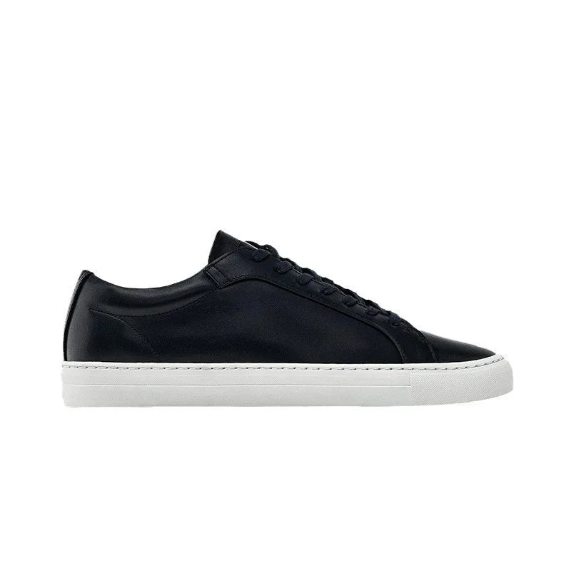 Black leather low-top sneaker with white rubber sole, minimalist streetwear style
