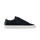 Black leather low-top sneaker with white rubber sole, minimalist streetwear style