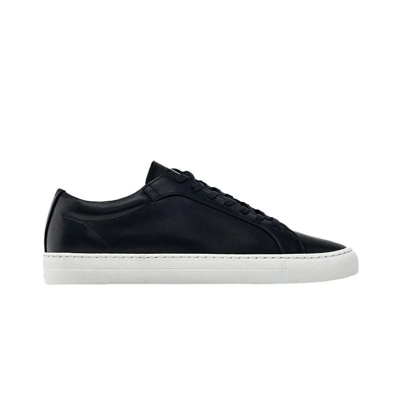 Black leather low-top sneaker with white rubber sole, minimalist streetwear style
