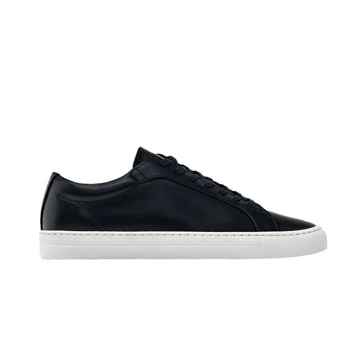 Black leather low-top sneaker with white rubber sole, minimalist streetwear style