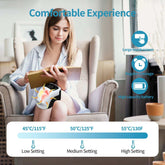 Woman in relaxed fit light blue shirt using a heated knee massager in a modern living room.