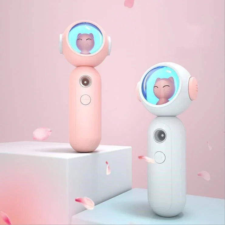 Cute handheld fans in pastel pink and white with cat face design and smooth plastic finish
