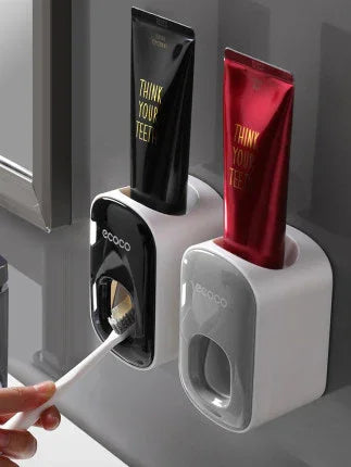 Wall-mounted toothpaste dispensers with black and red tubes, modern bathroom accessory