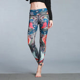 Woman wearing colorful high-waisted leggings with bird and feather print, slim fit