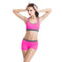 Woman wearing pink athletic sports bra and shorts with gray trim, fitted activewear set