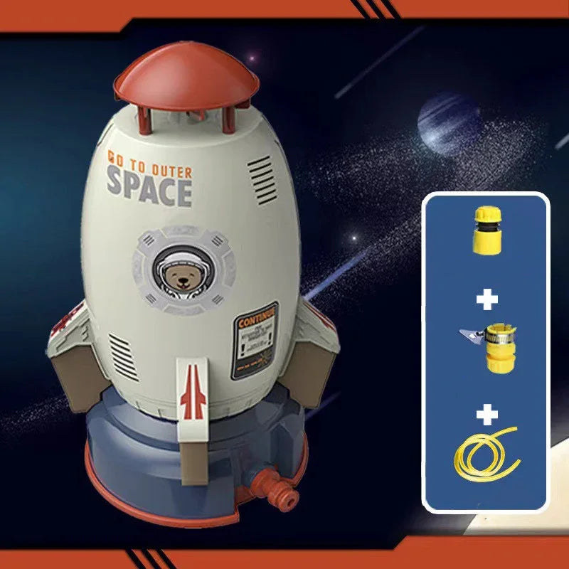 Toy rocket-shaped water sprinkler in gray and red plastic, with included hose adapters.