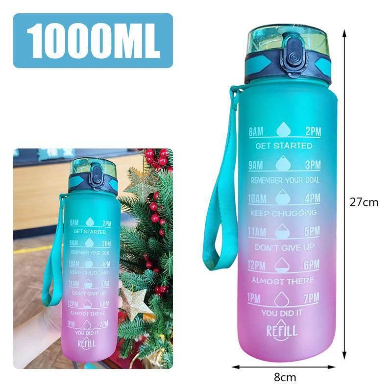 Gradient blue and pink 1000ml water bottle with motivational time markers and secure flip lid, 27cm tall.
