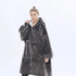 Woman wearing oversized dark grey fleece hoodie with front pocket and relaxed fit.