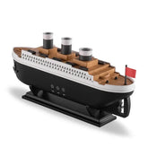 Titanic-inspired ship model with wood grain finish, black base, and red flag accent