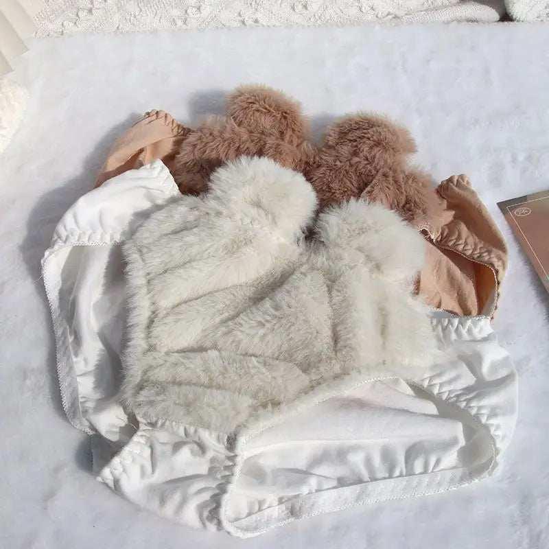 Fuzzy cropped tops in white and tan, featuring soft faux fur material and sleeveless design