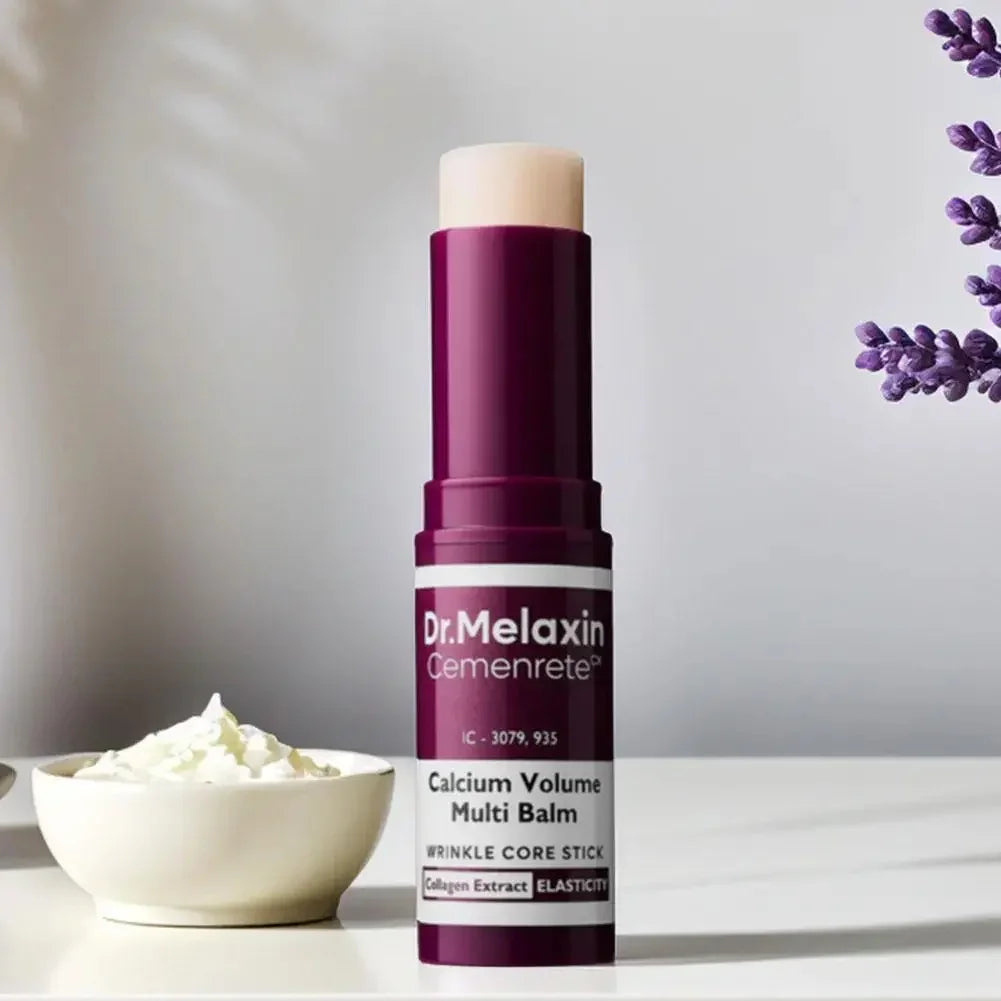 Purple and white multi balm stick for skincare on a light surface with lavender and cream decor