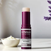 Purple and white multi balm stick for skincare on a light surface with lavender and cream decor