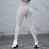 High-waisted light grey seamless leggings with contour fit, worn outdoors with white sneakers.