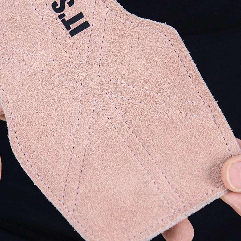 Close-up of a pink suede fabric patch with detailed stitching and part of printed text.