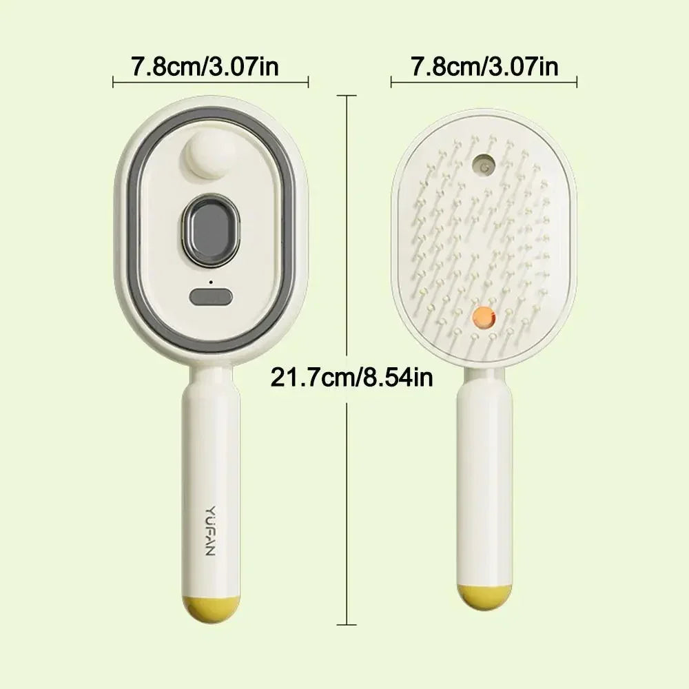 Cream and yellow oval grooming brush with ergonomic handle, shown front and back, 21.7cm long