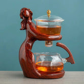 Elegant wood and glass tea set with a sculpted figure design, modern minimalist style