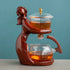 Elegant wood and glass tea set with a sculpted figure design, modern minimalist style