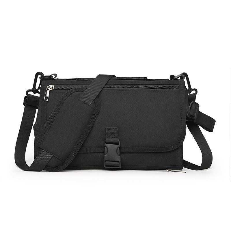 Black nylon crossbody bag with adjustable strap, zipper pocket, and buckle closure