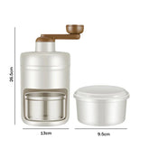 Beige and white manual kitchen grinder with stainless steel container, modern design, compact size.