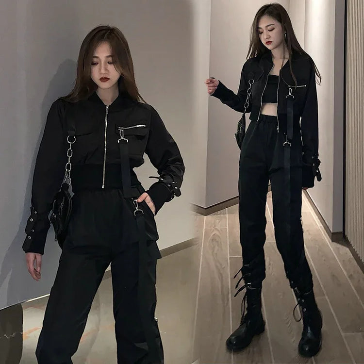 Woman wearing black cropped jacket with zipper, matching high-waisted joggers, and combat boots