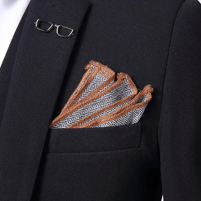 Black blazer with herringbone pocket square featuring brown frayed edges, slim fit style
